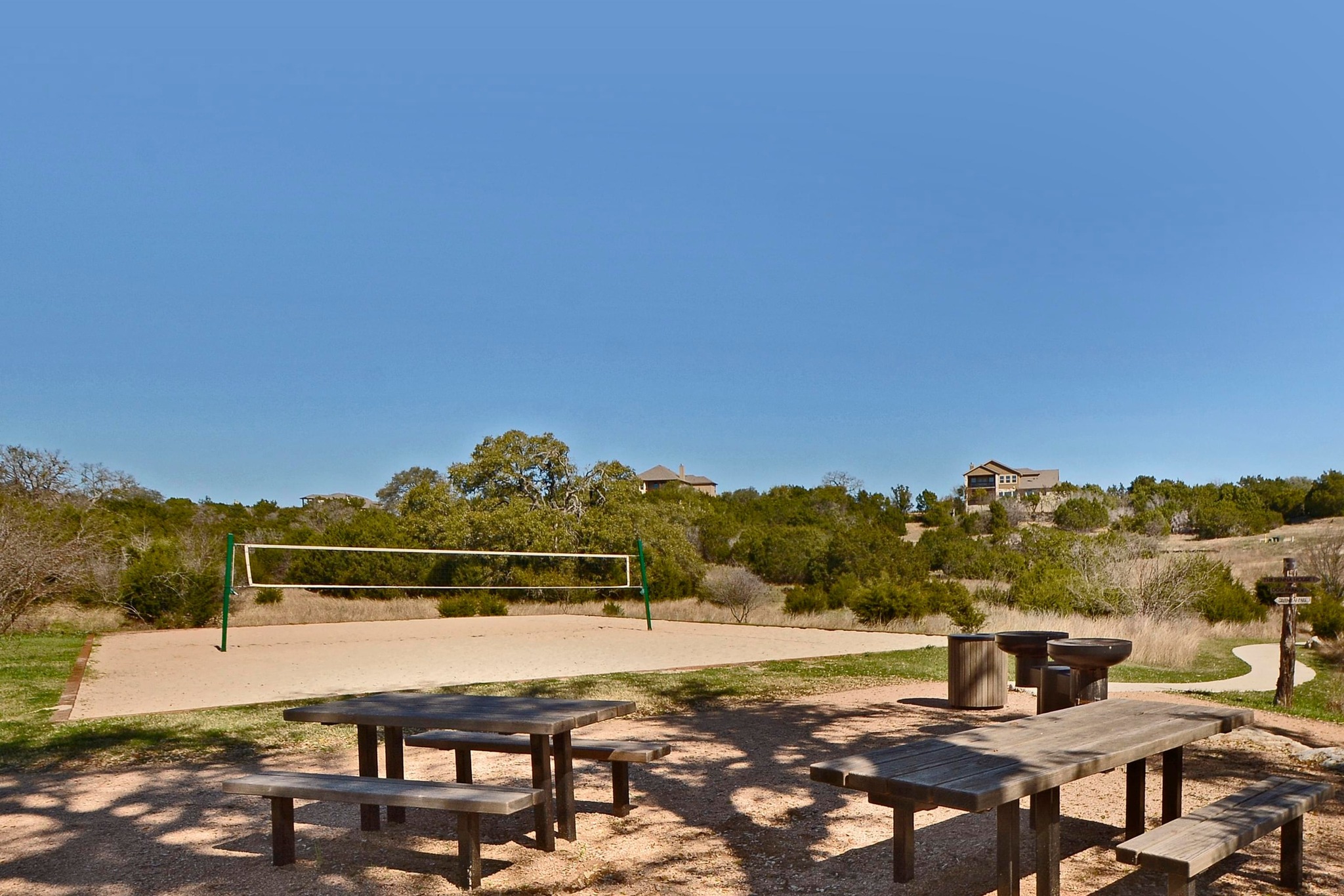 68 Rancho Trail Georgetown, TX 78628 - Photo 38 of 39 Enjoy outdoor recreation with a sand volleyball court and picnic area amidst natural landscaping.