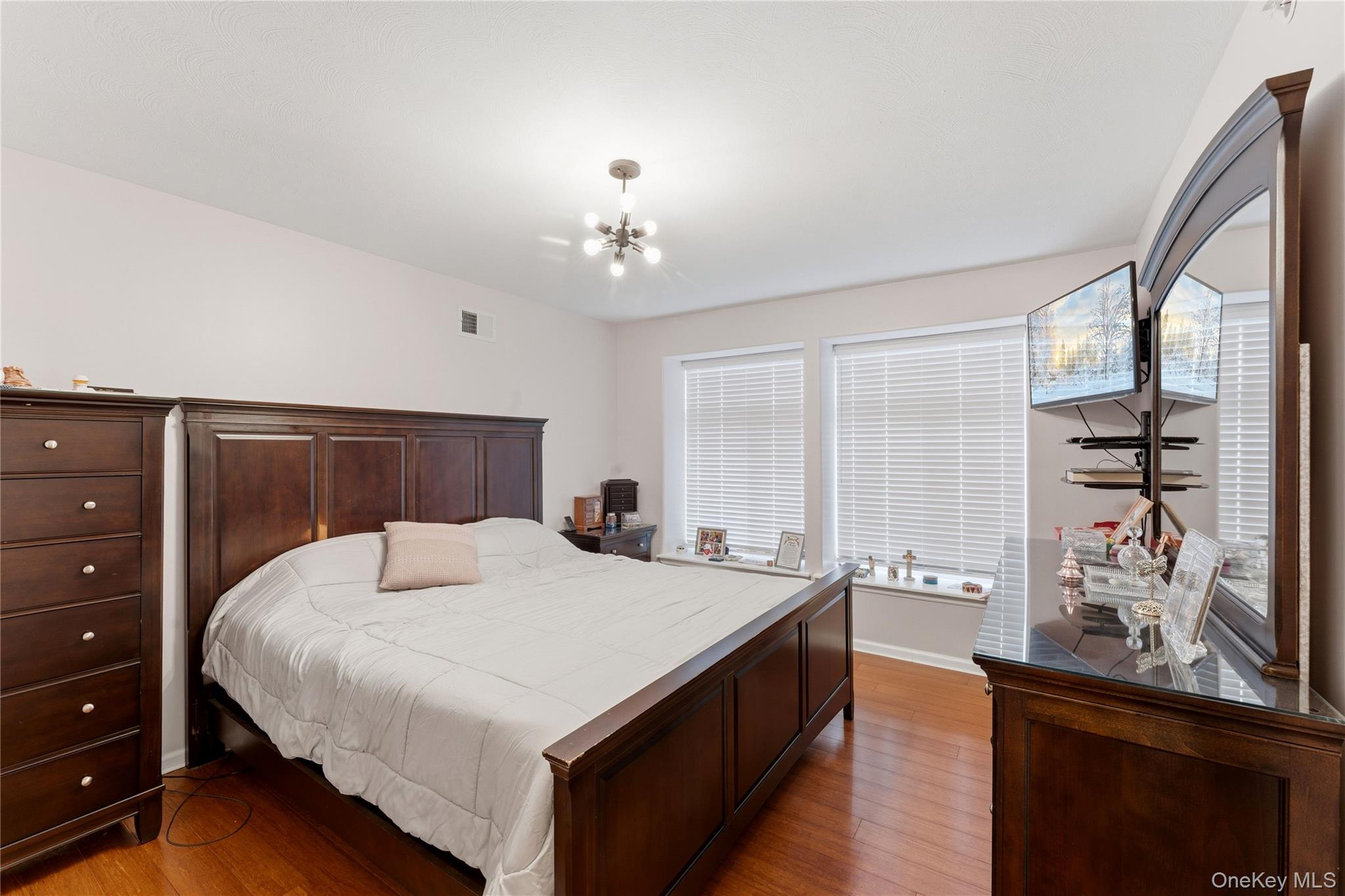 136 Meridian Boulevard Queens, NY 11692 - Photo 12 of 29 a bedroom with a large bed and a dresser