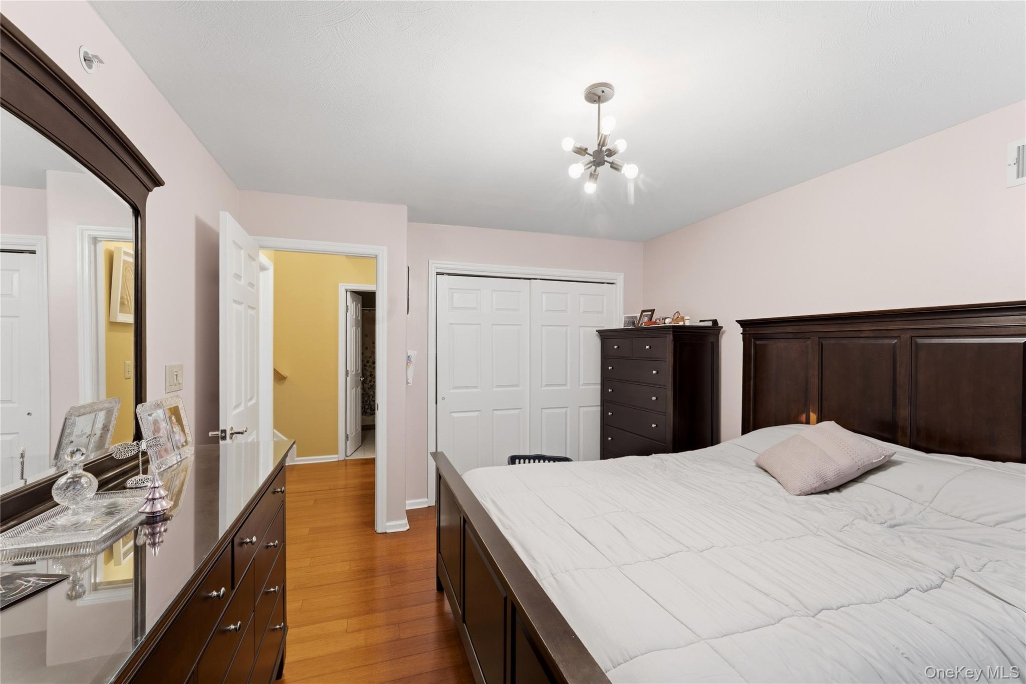 136 Meridian Boulevard Queens, NY 11692 - Photo 13 of 29 a large bedroom with a large bed and wooden floor