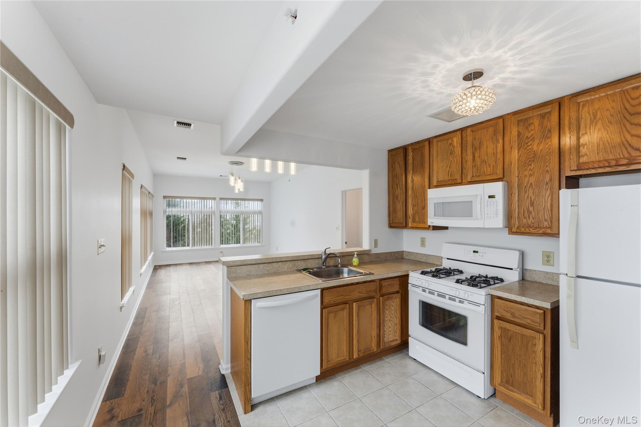 136 Meridian Boulevard Queens, NY 11692 - Photo 20 of 29 a kitchen with a stove a sink and a refrigerator