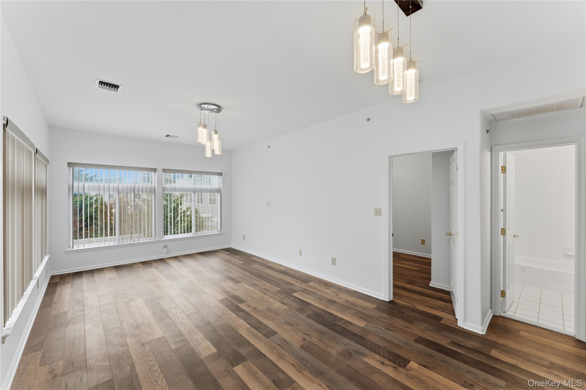 136 Meridian Boulevard Queens, NY 11692 - Photo 22 of 29 a view of an empty room with wooden floor and a window