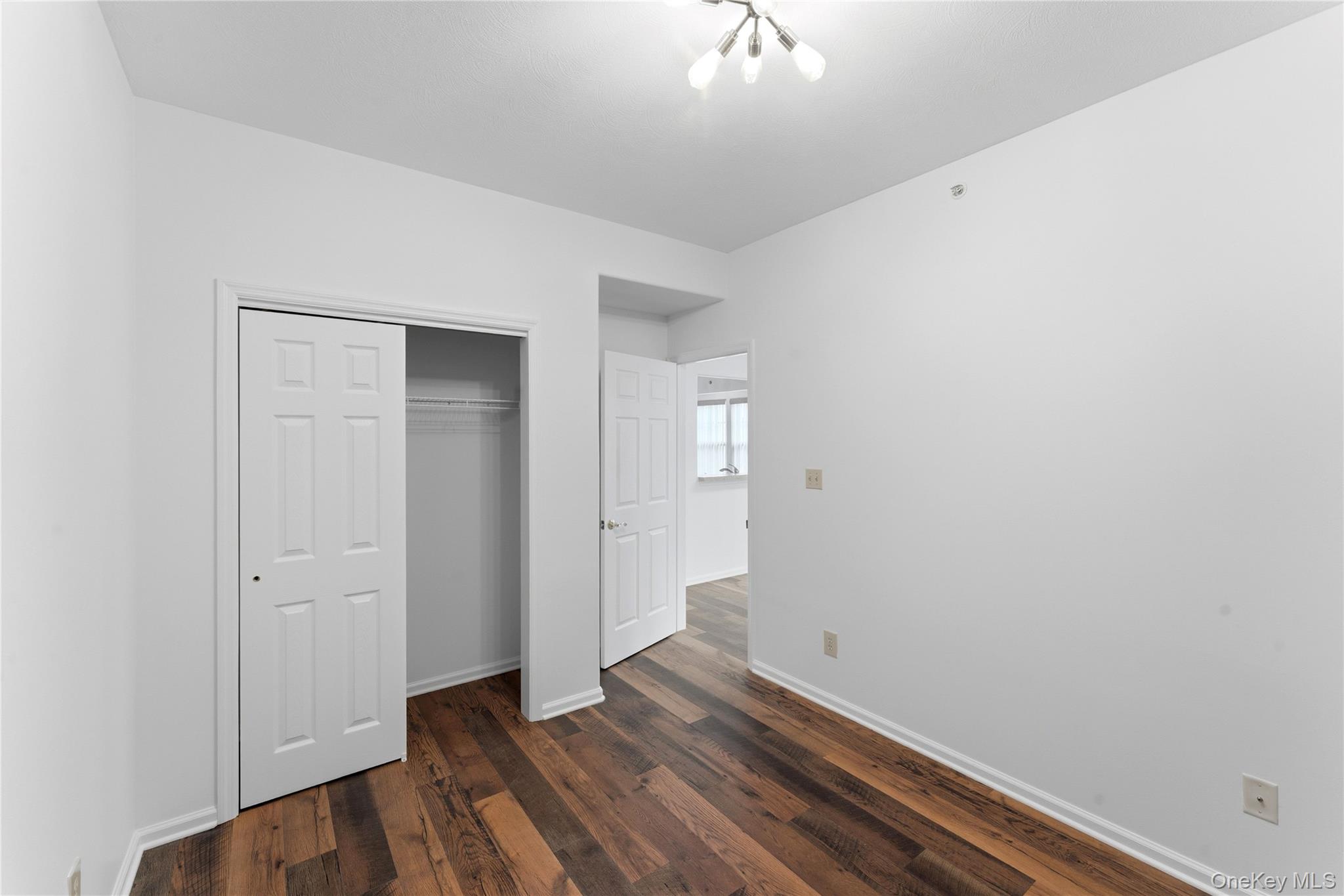 136 Meridian Boulevard Queens, NY 11692 - Photo 25 of 29 a view of an empty room with wooden floor