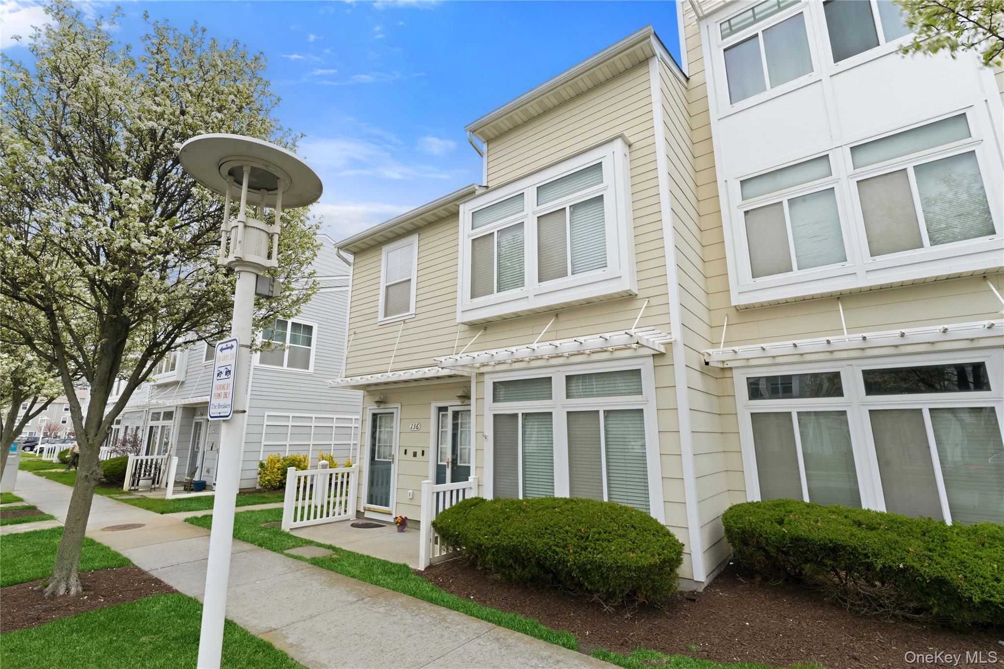 136 Meridian Boulevard Queens, NY 11692 - Photo 27 of 29 a front view of a building with a garden