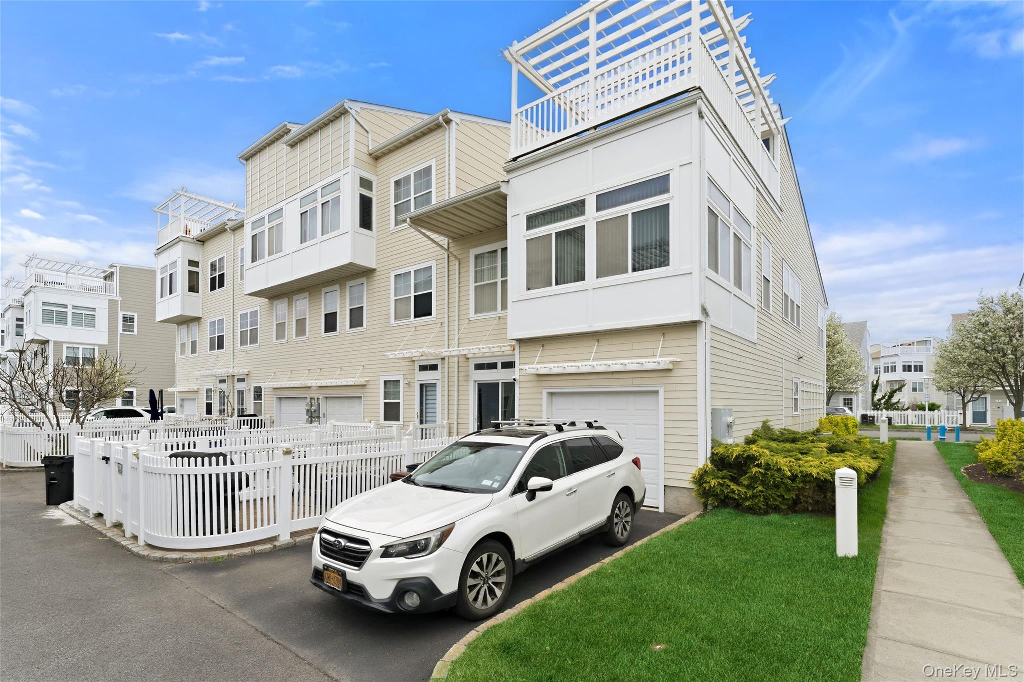 136 Meridian Boulevard Queens, NY 11692 - Photo 3 of 29 a car parked in front of a white building