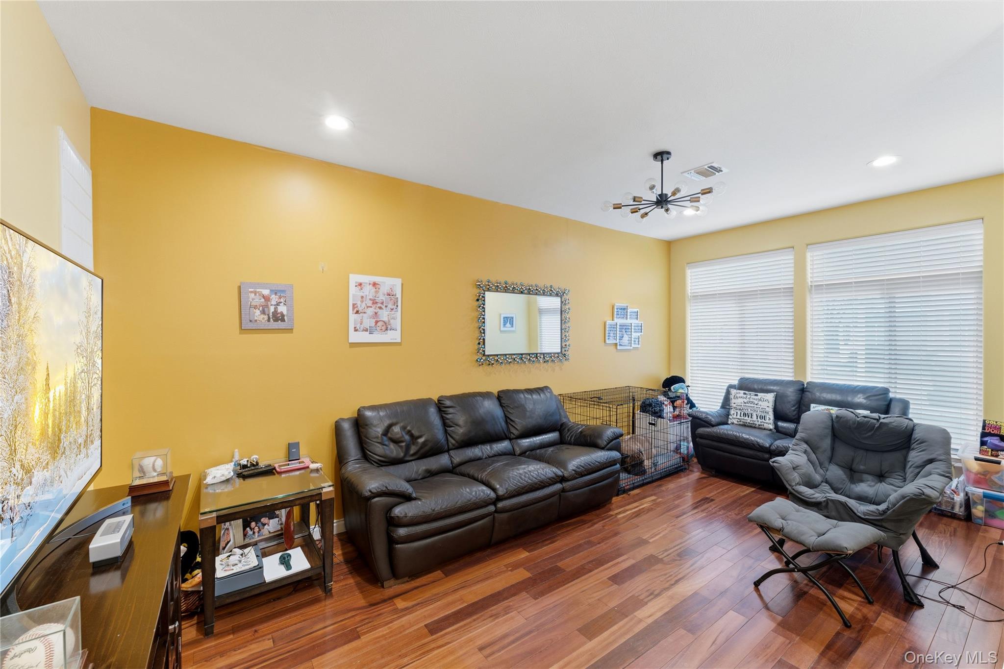 136 Meridian Boulevard Queens, NY 11692 - Photo 6 of 29 a living room with furniture and a wooden floor