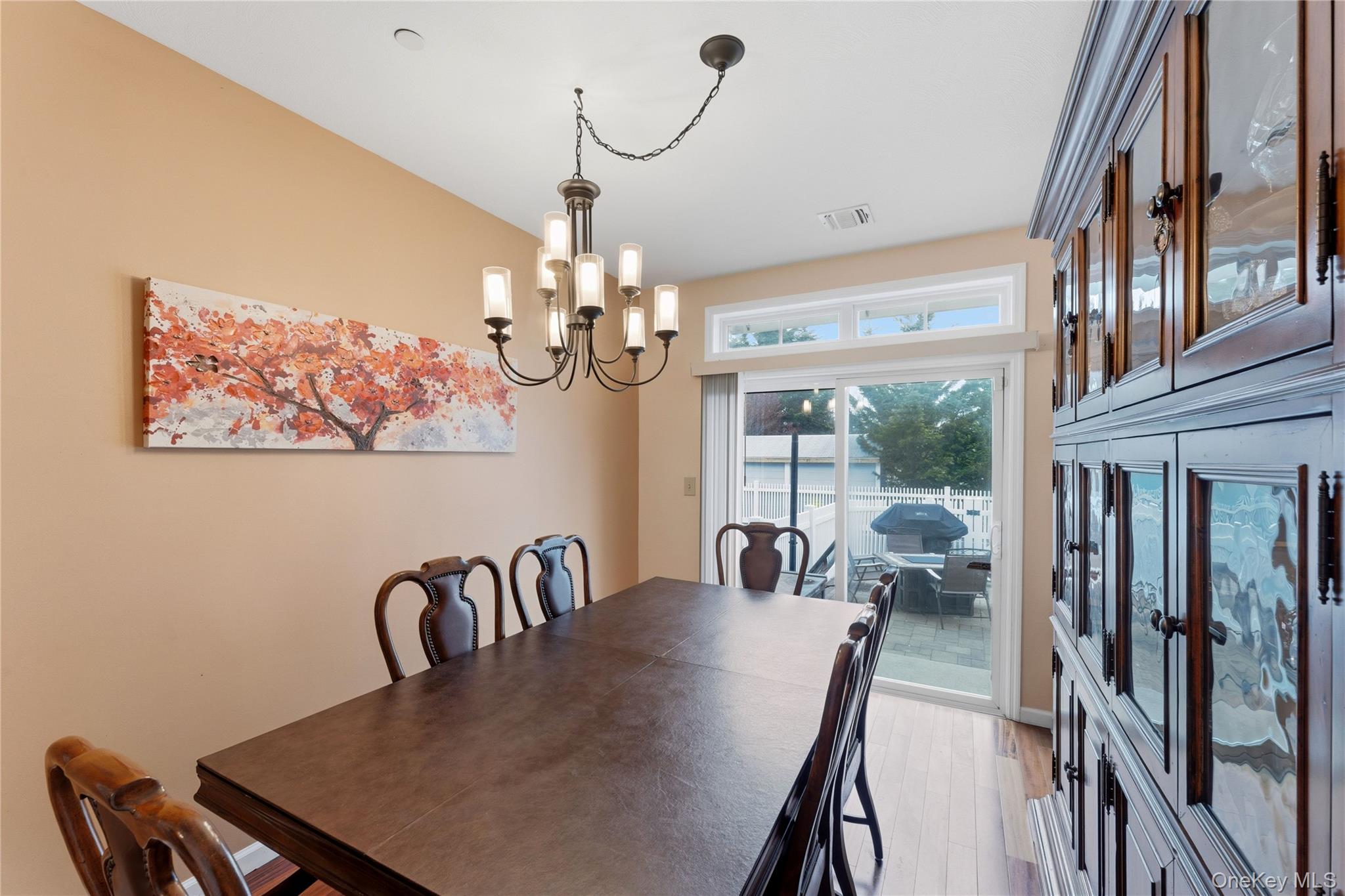 136 Meridian Boulevard Queens, NY 11692 - Photo 9 of 29 a view of a dining room with furniture a chandelier and large windows