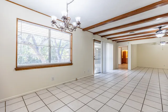 a kitchen with cabinets and a window