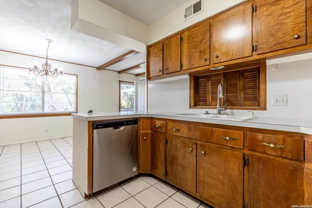 a kitchen with a refrigerator a stove top oven and cabinets