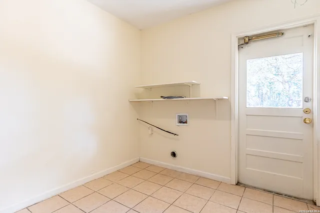 a view of a house with a small yard and wooden fence