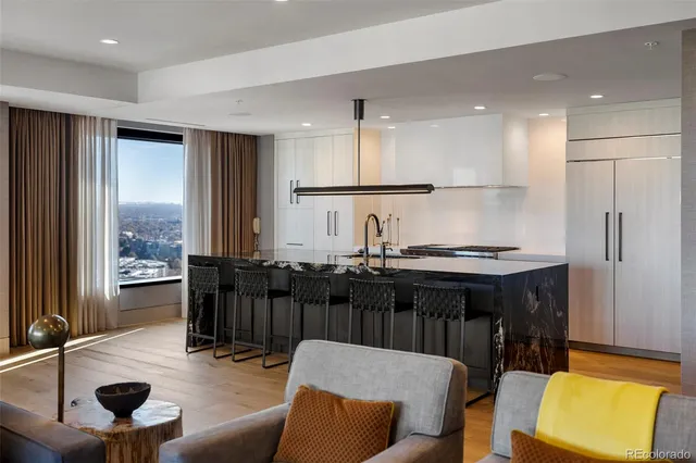 a kitchen with a dining table chairs and a refrigerator