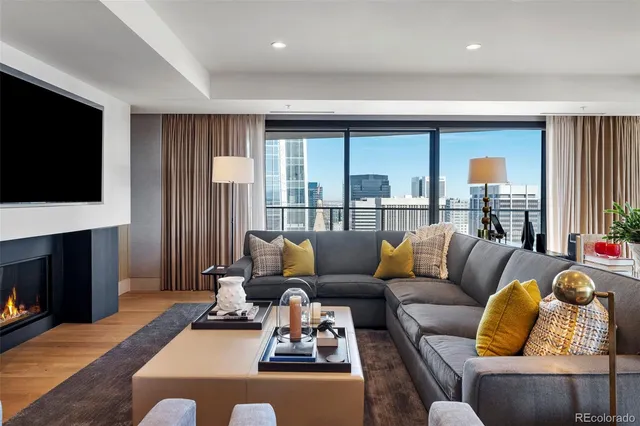 a living room with furniture fireplace and flat screen tv