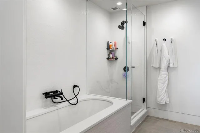 a bathroom with a bath tub and shower