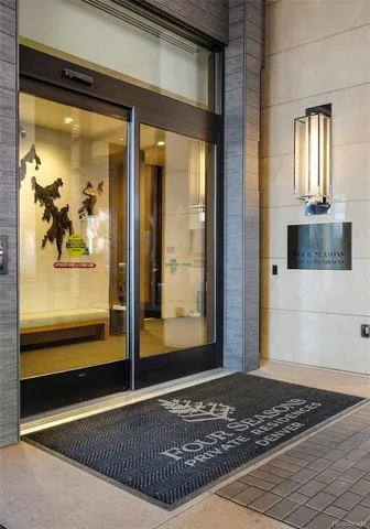 a view of a hallway with wooden floor and a rug