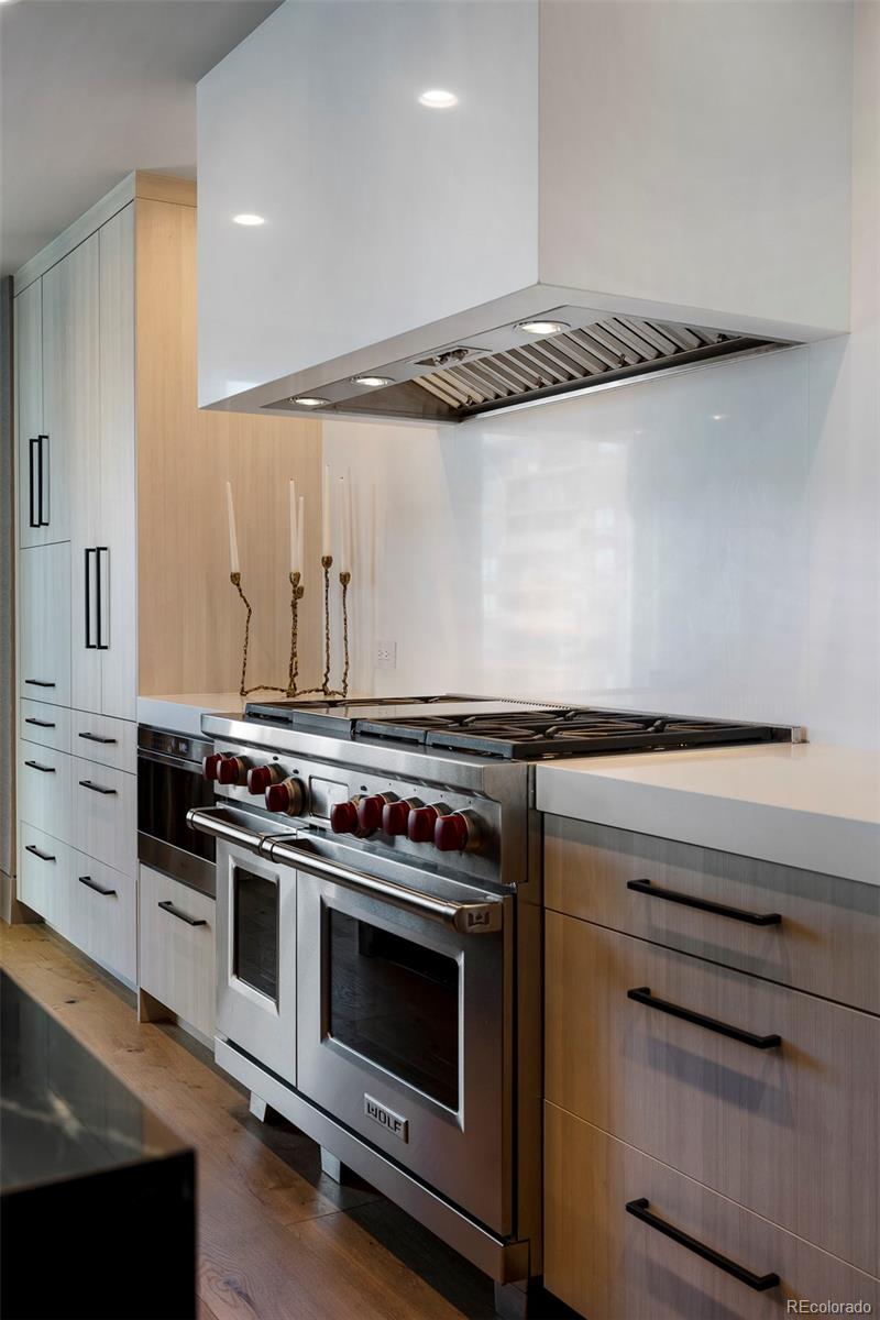 1133 14th Street, Unit 2820 Denver, CO 80202 - Photo 6 of 34 a kitchen with granite countertop a stove and a microwave