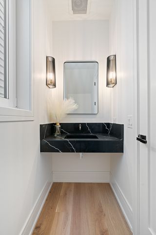 a close view of a sink and a microwave oven in a bathroom