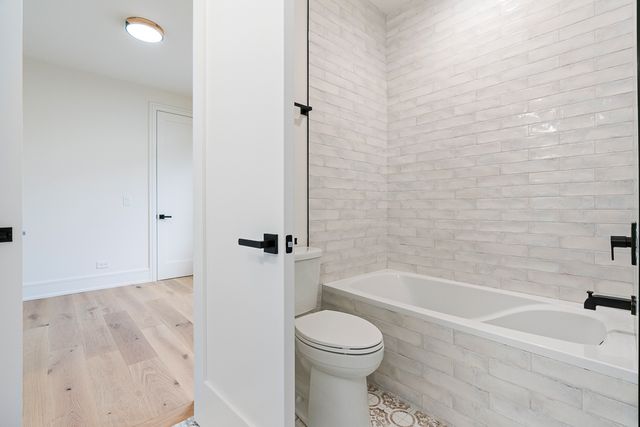 a bathroom with a toilet and a bathtub