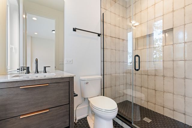 a bathroom with a sink toilet and shower