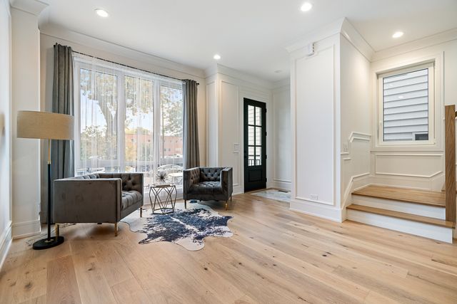 a view of a livingroom with workspace and a window