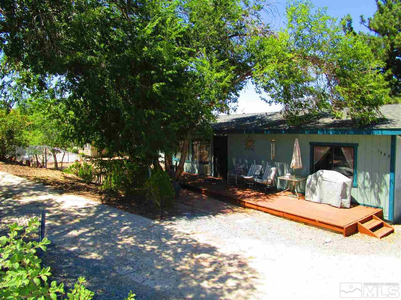 a view of a house with backyard sitting area and porch