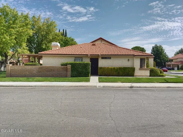 a front view of a house with a garden and garage