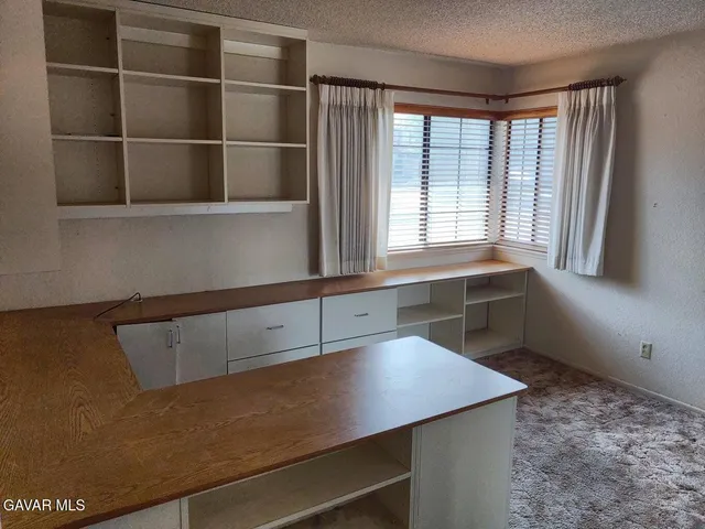 a utility room with cabinets and window