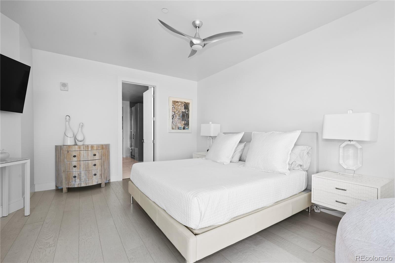 4200 West 17th Avenue, Unit 618 Denver, CO 80204 - Photo 12 of 38 a bedroom with a bed and a flat screen tv