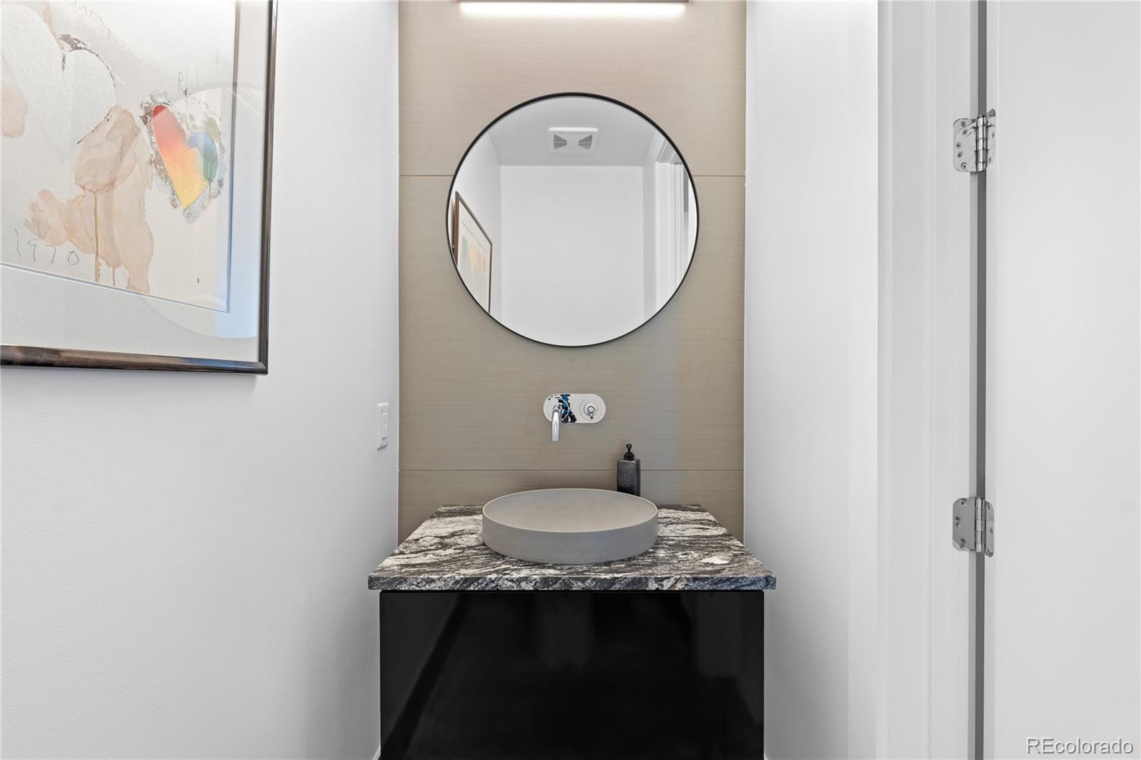 4200 West 17th Avenue, Unit 618 Denver, CO 80204 - Photo 22 of 38 a bathroom with a granite countertop sink and a mirror