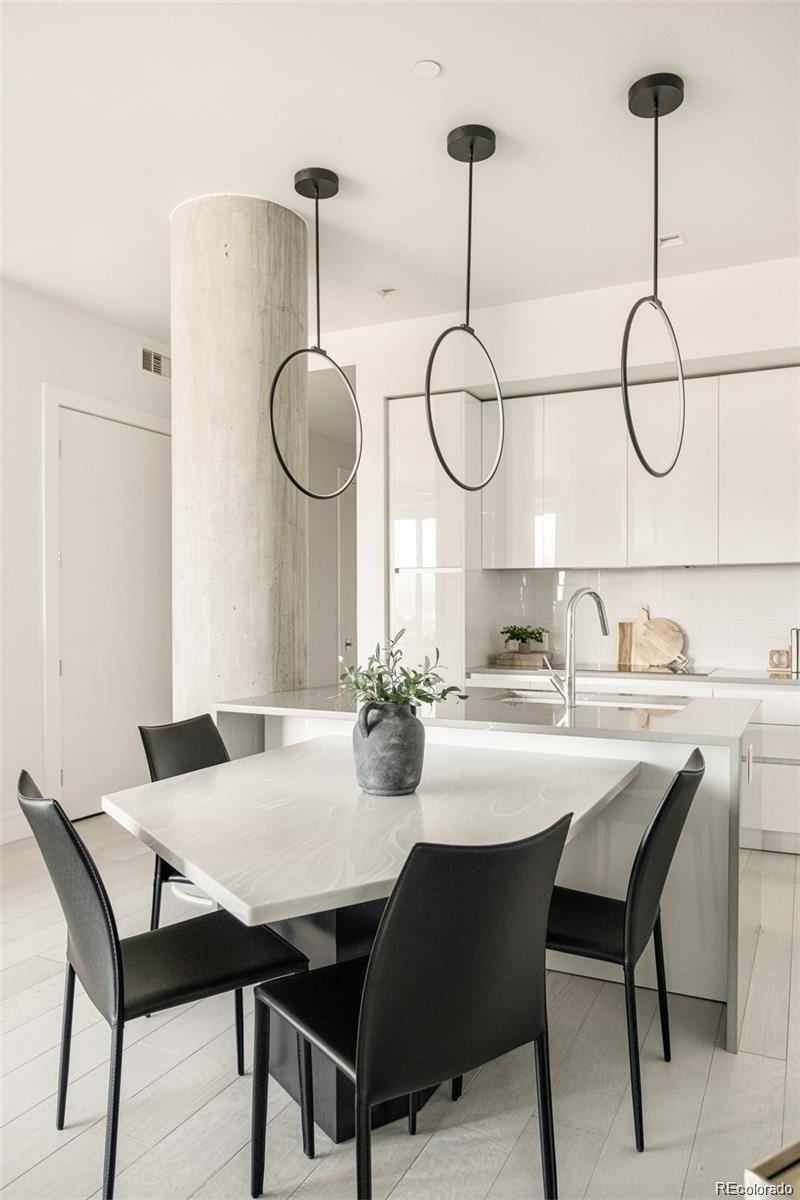 4200 West 17th Avenue, Unit 618 Denver, CO 80204 - Photo 7 of 38 a view of a dining room and chandelier