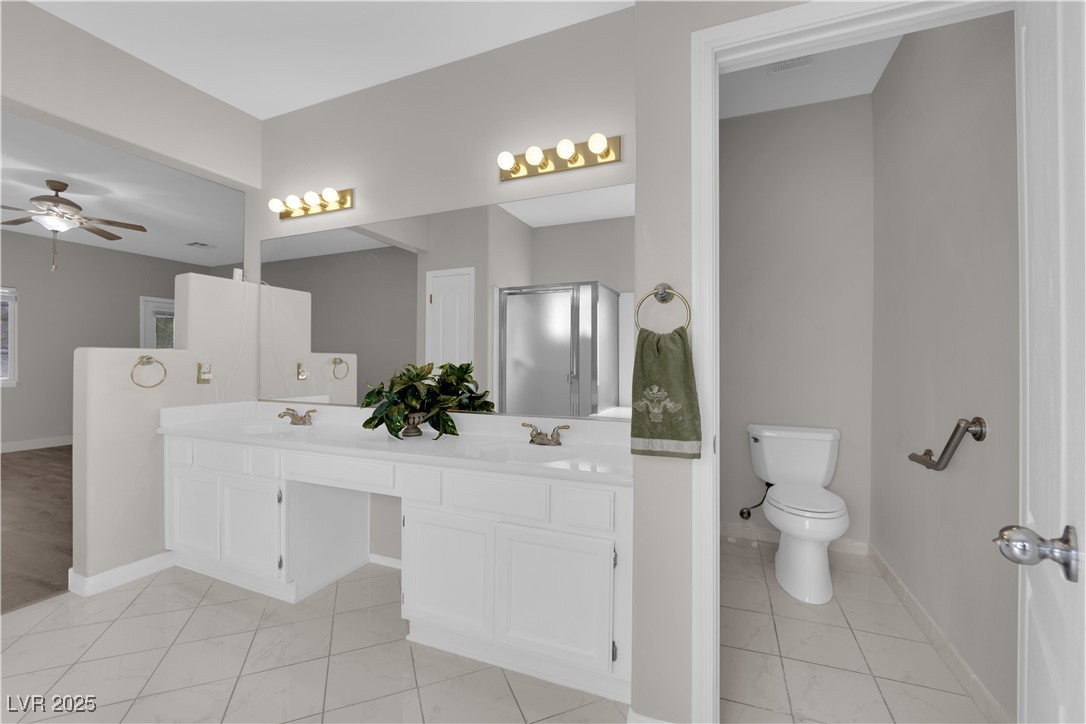 650 West Victory Road Henderson, NV 89015 - Photo 15 of 35 Full bathroom with double vanity and a ceiling fan