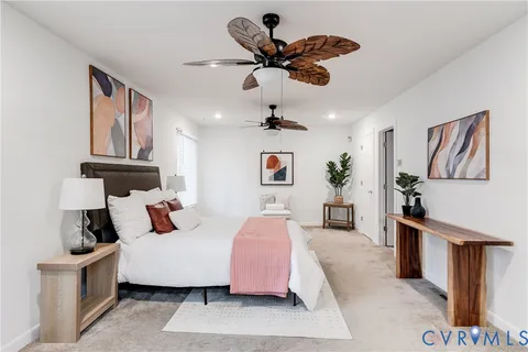 a bedroom with a bed wooden floor and ceiling fan