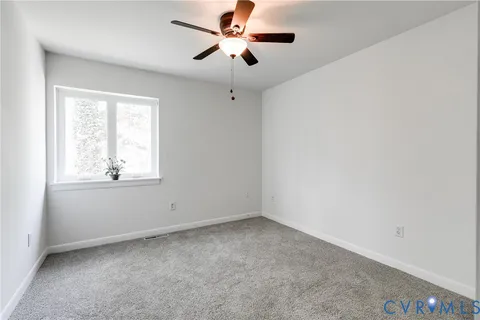 a view of room with a ceiling fan and window