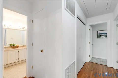 a view of a hallway view with wooden floor and staircase