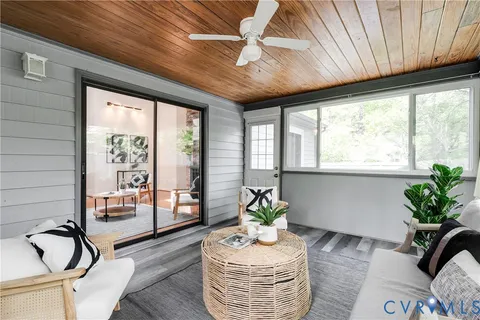 a living room with furniture and floor to ceiling windows