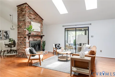 a living room with fireplace furniture and a window
