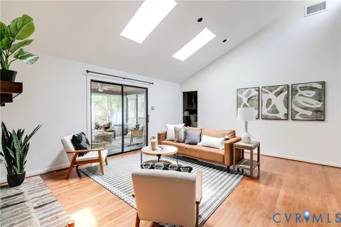 a living room with furniture and wooden floor