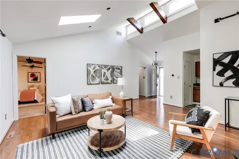 a living room with furniture and wooden floor