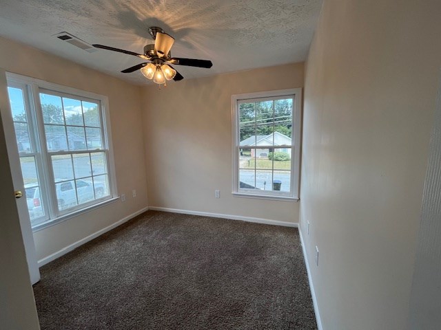 2812 8th Street Columbus, GA 31906 - Photo 8 of 14 an empty room with windows and fan