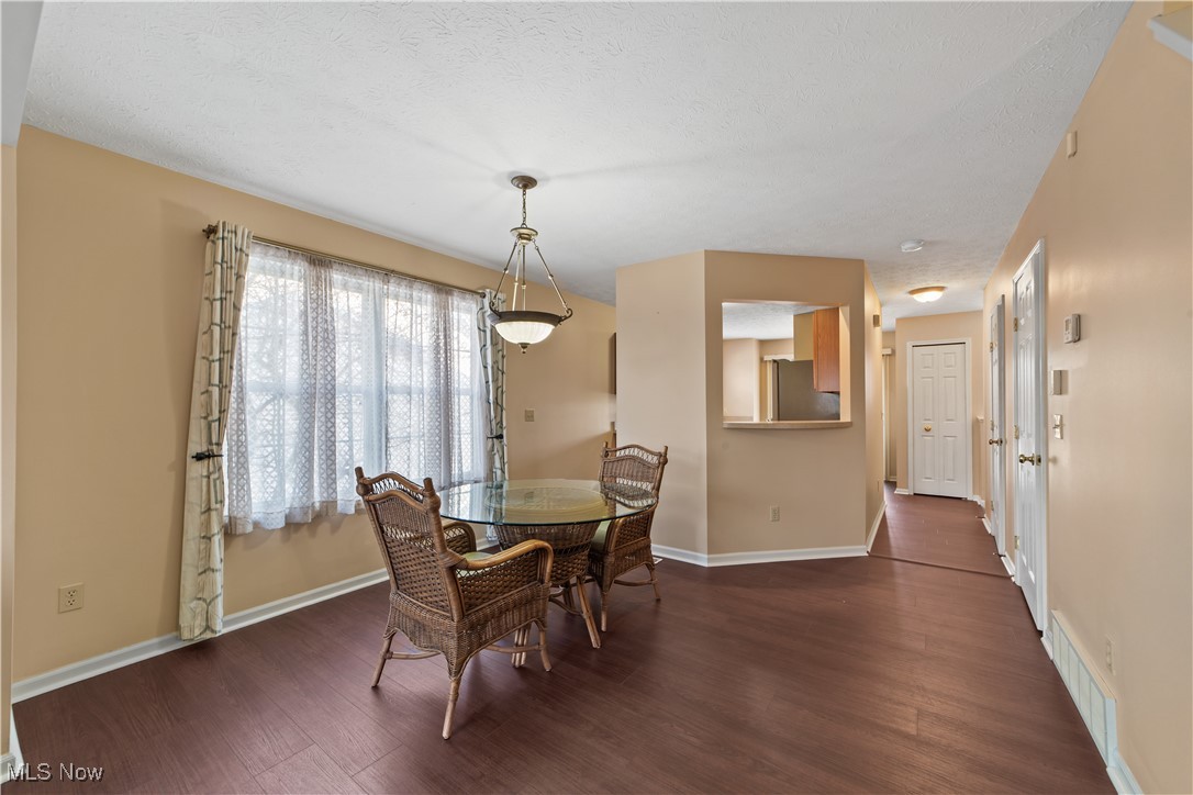 4364 Sexton Road Cleveland, OH 44105 - Photo 10 of 50 Dining area with dark wood-style floors and a textured ceiling