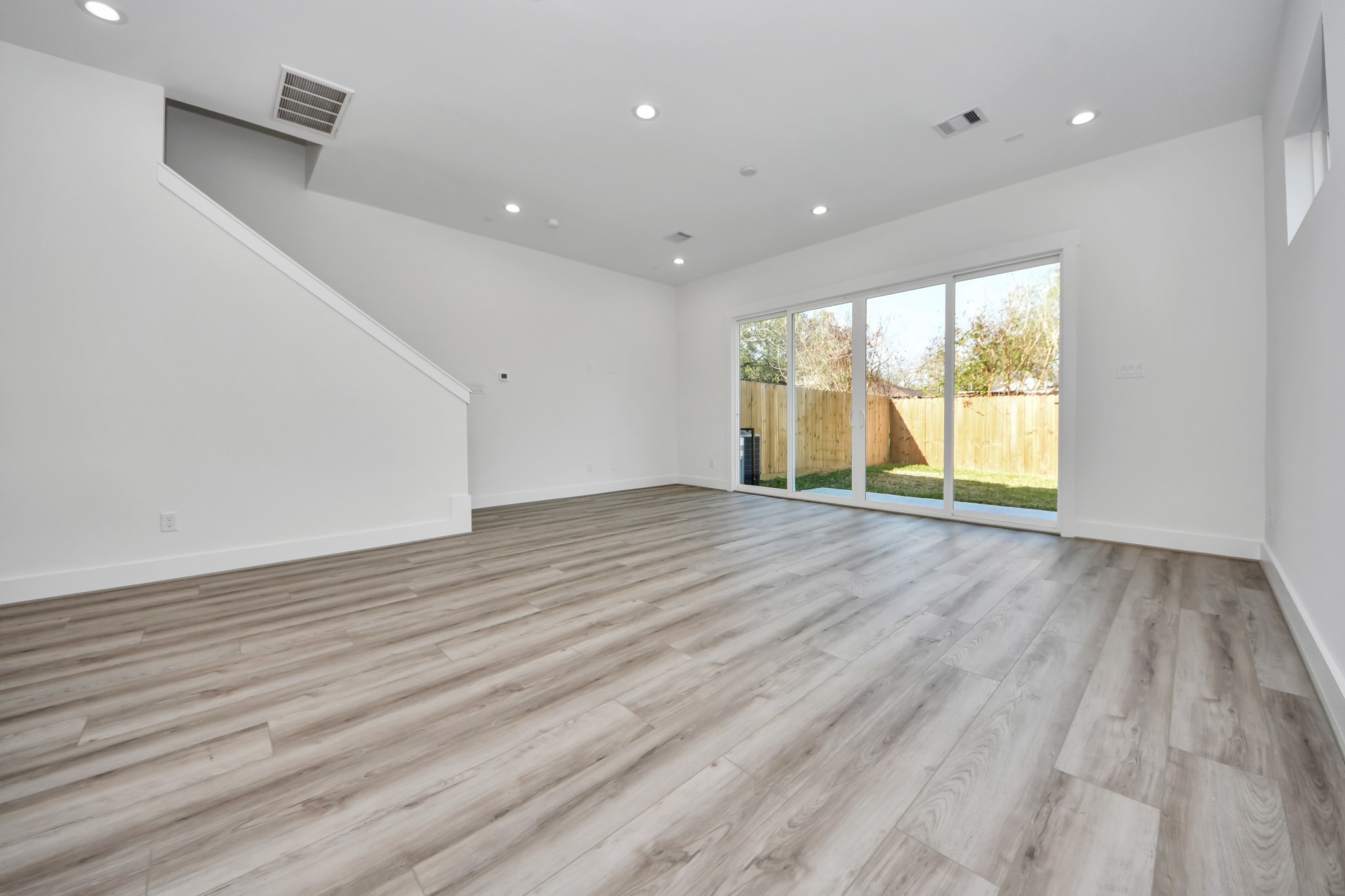 7012 St Augustine Street Houston, TX 77021 - Photo 14 of 45 an empty room with wooden floor and windows
