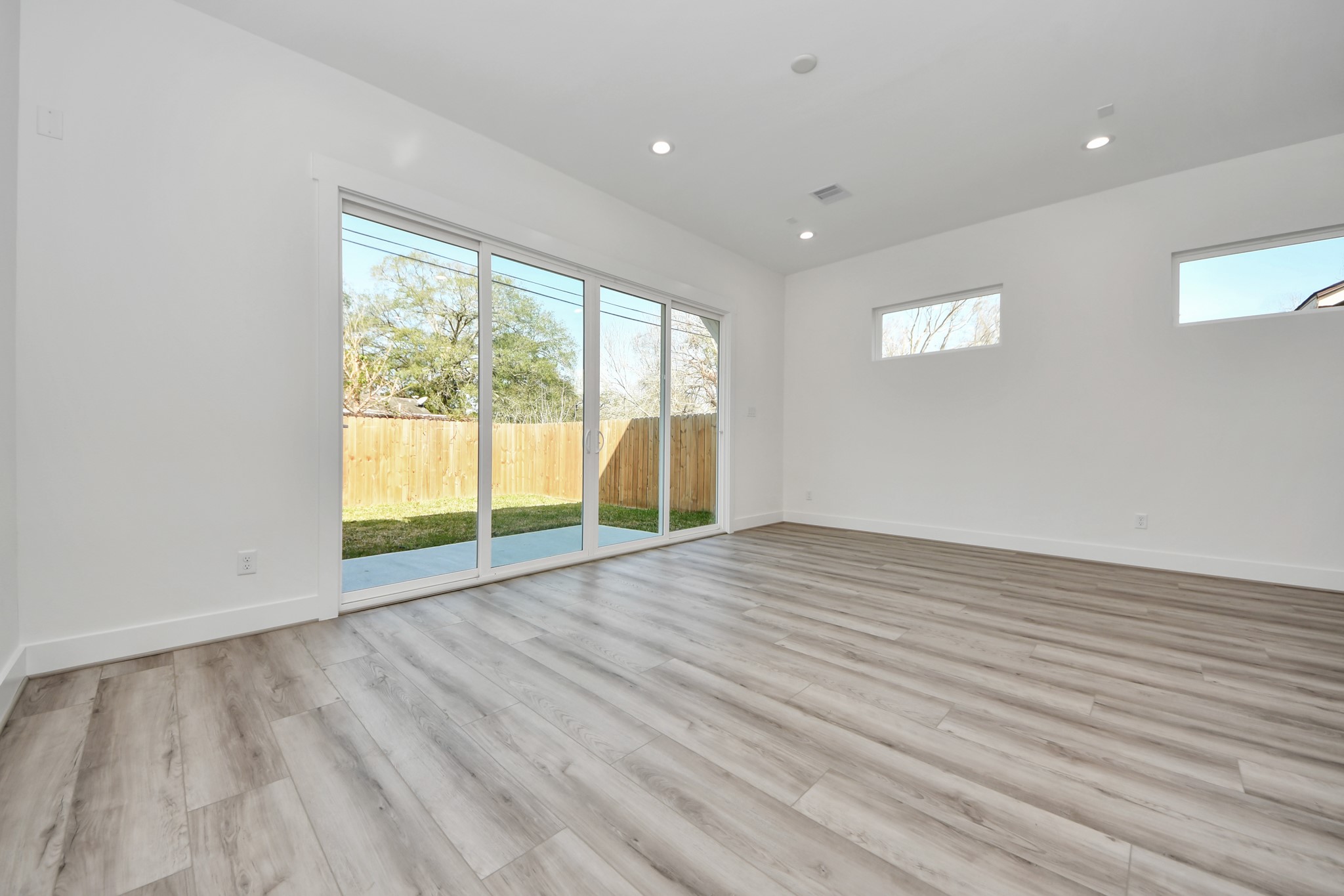 7012 St Augustine Street Houston, TX 77021 - Photo 16 of 45 wooden floor in an empty room with a window