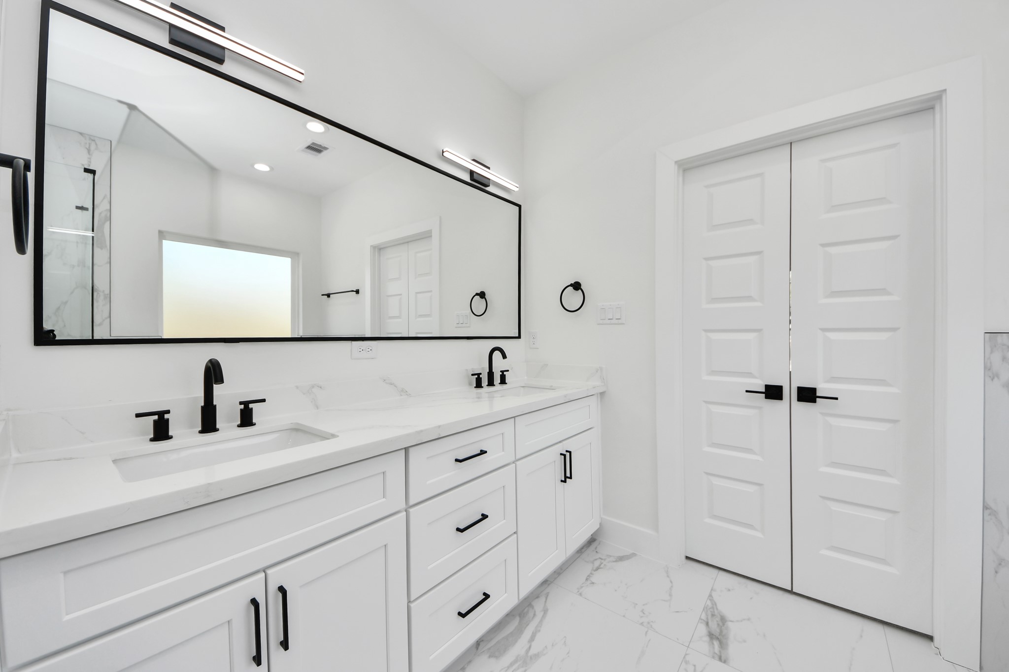 7012 St Augustine Street Houston, TX 77021 - Photo 22 of 45 a bathroom with a double vanity sink and mirror