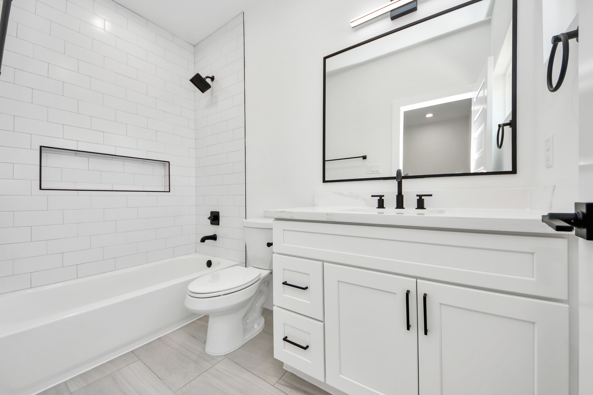 7012 St Augustine Street Houston, TX 77021 - Photo 28 of 45 a bathroom with a toilet a sink a mirror and a bathtub