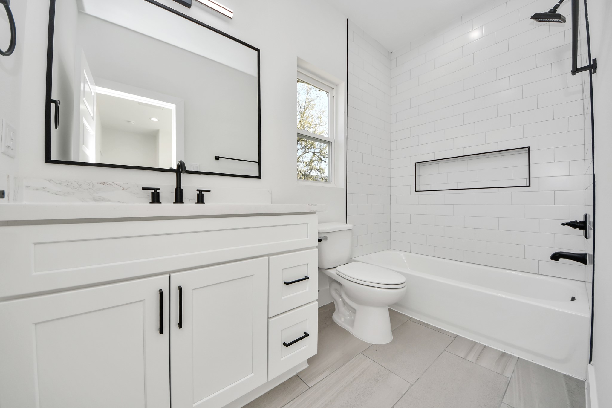7012 St Augustine Street Houston, TX 77021 - Photo 31 of 45 a bathroom with a toilet a sink a tub and mirror