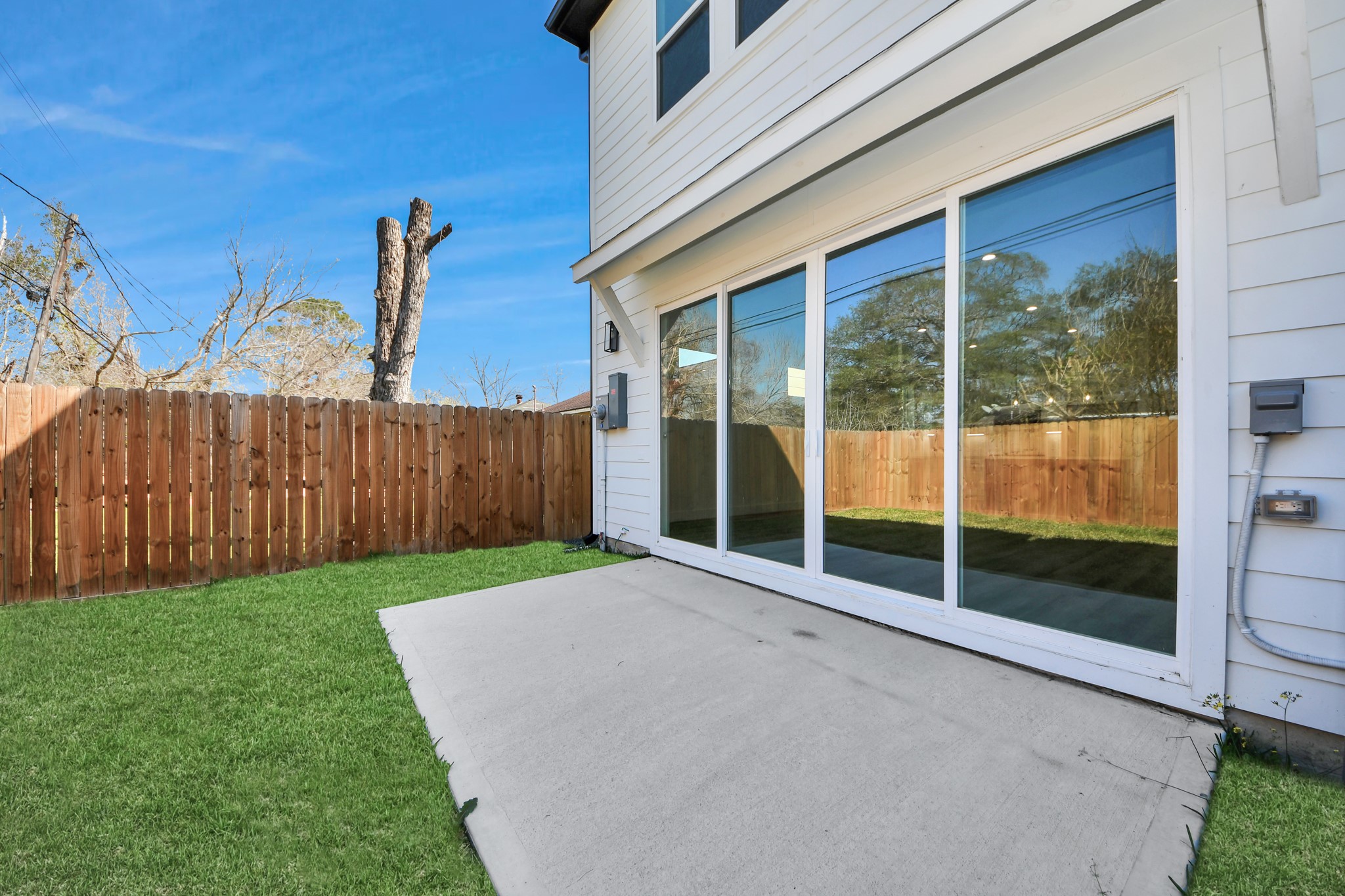 7012 St Augustine Street Houston, TX 77021 - Photo 33 of 45 a view of a backyard with floor to ceiling window and wooden fence