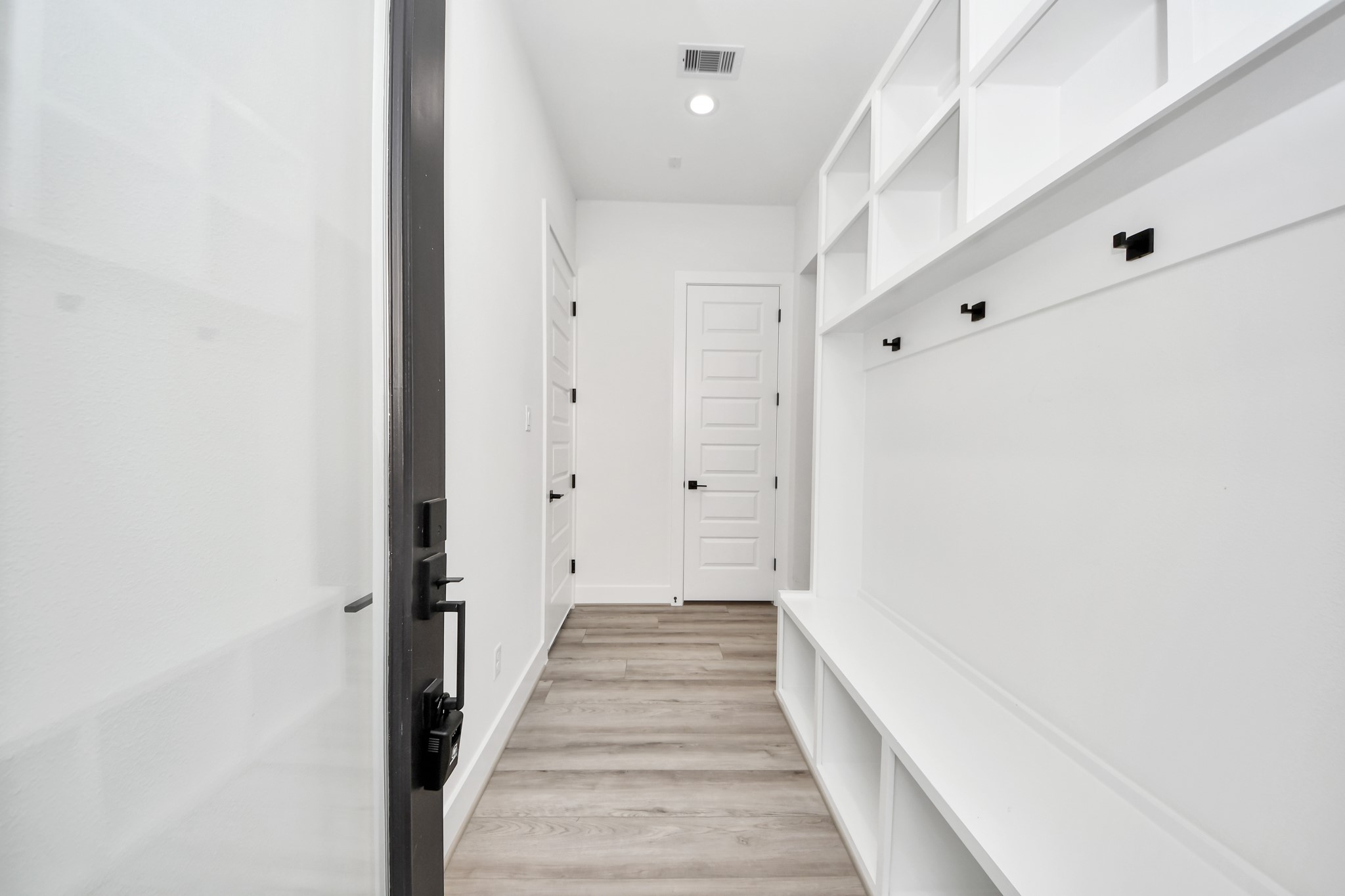 7012 St Augustine Street Houston, TX 77021 - Photo 4 of 45 a view of a hallway with wooden floor