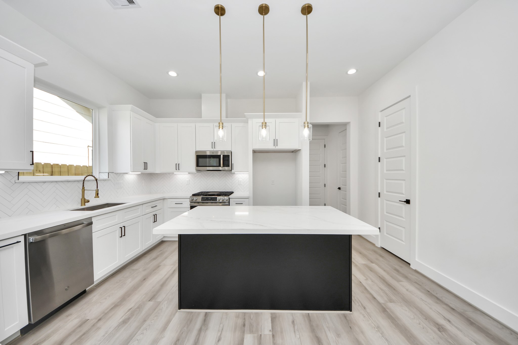 7012 St Augustine Street Houston, TX 77021 - Photo 6 of 45 a large kitchen with cabinets and wooden floor