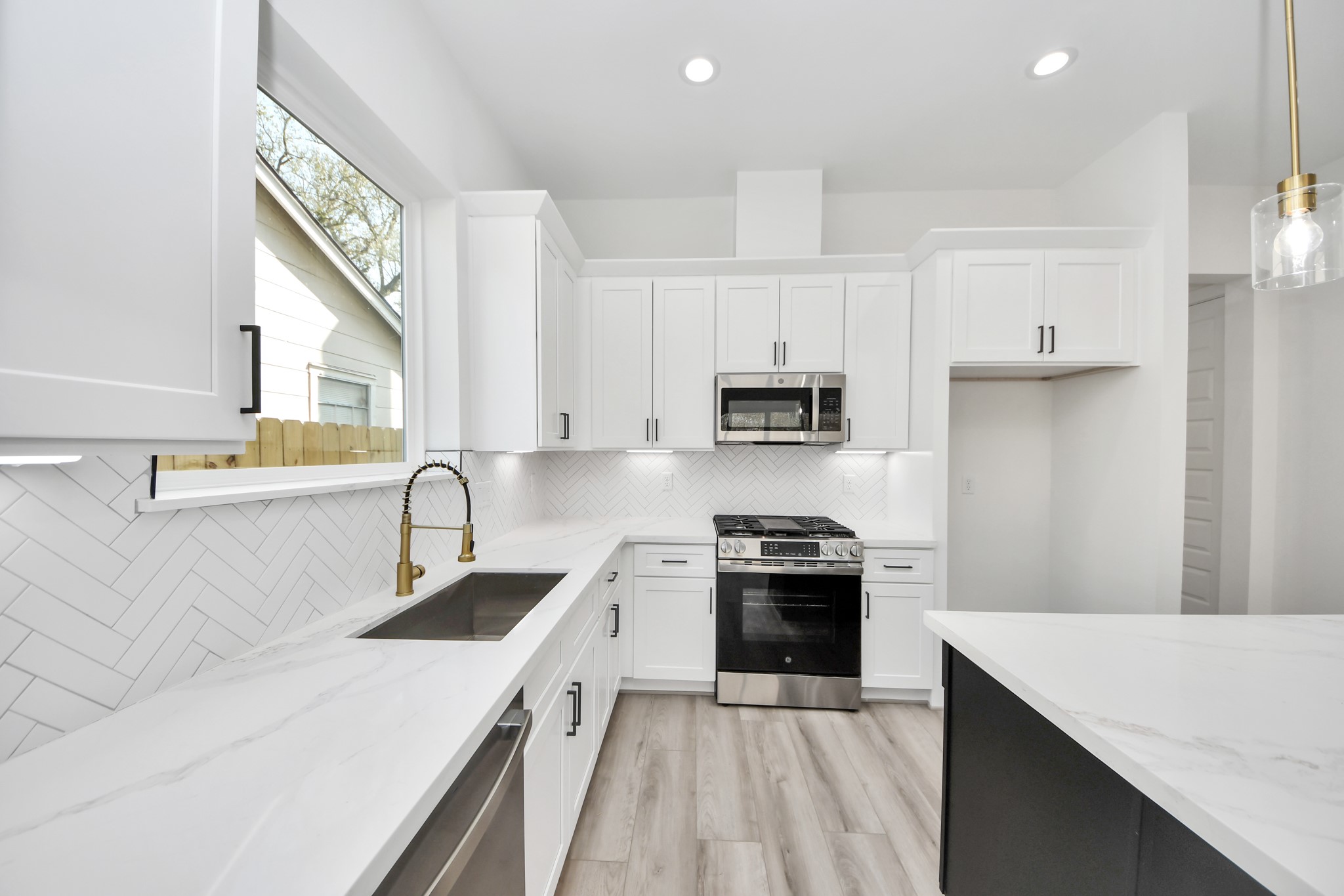 7012 St Augustine Street Houston, TX 77021 - Photo 8 of 45 a kitchen with white cabinets appliances and sink