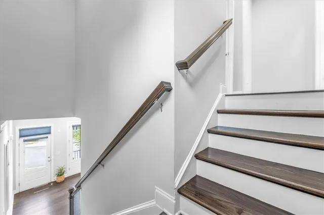 a white toilet sitting next to a white wall