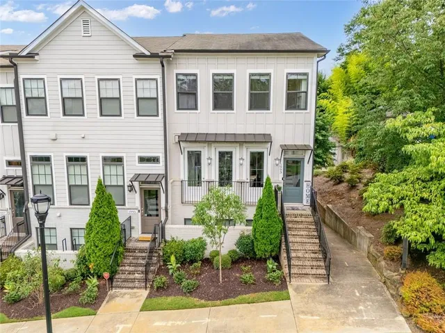 a white toilet sitting next to a white wall
