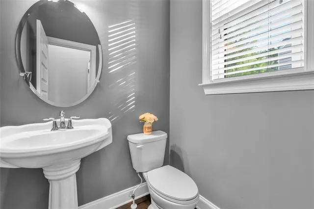 a bathroom with a sink a toilet a mirror a vanity a shower and vanity